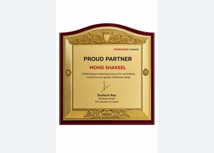 Mahindra Finance Proud Partner plaque presented to Mohd Shakeel by the Business Head for Pre-Owned Car Loans
